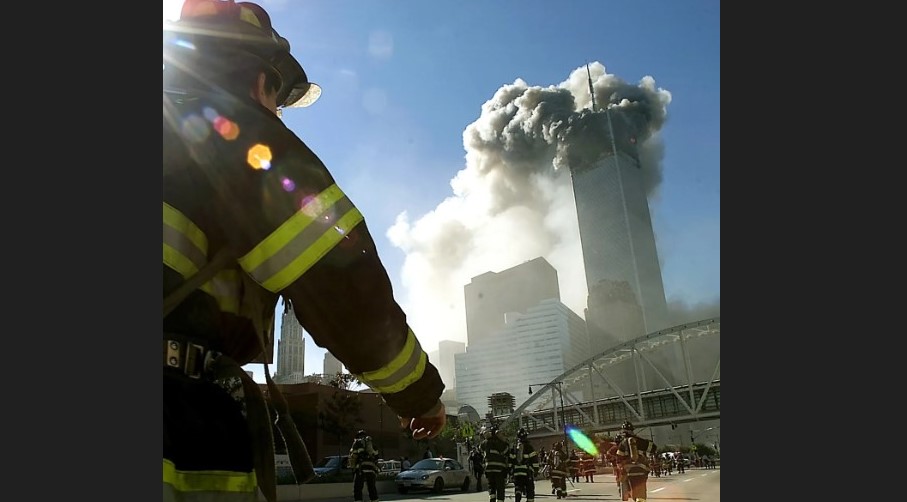 Fire firefighter near one of the twin towers as it collapses during the 9/11 terrorist attacks.