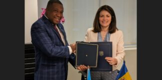 Saint Lucia Foreign Minister Alva Baptiste shakes hands after establishing diplomatic relations.