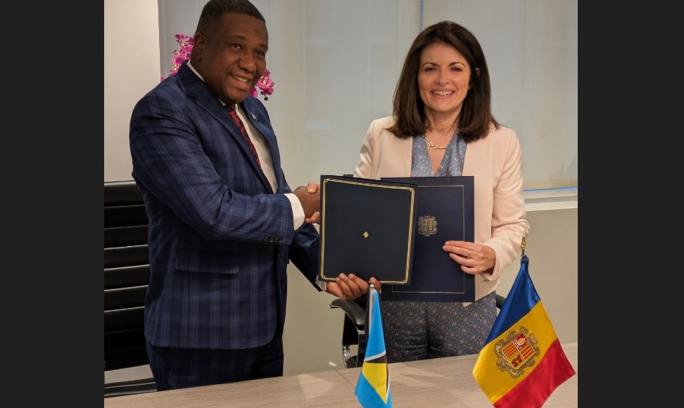 Saint Lucia Foreign Minister Alva Baptiste shakes hands after establishing diplomatic relations.