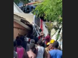 People on the scene where an ambulance crashed into a house in Dennery.