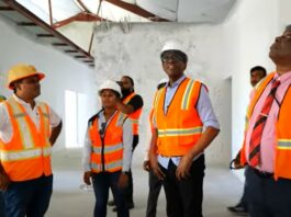 Prime Minister Philip J. Pierre and other officials tour the St. Jude Hospital reconstruction project.