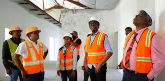 Prime Minister Philip J. Pierre and other officials tour the St. Jude Hospital reconstruction project.