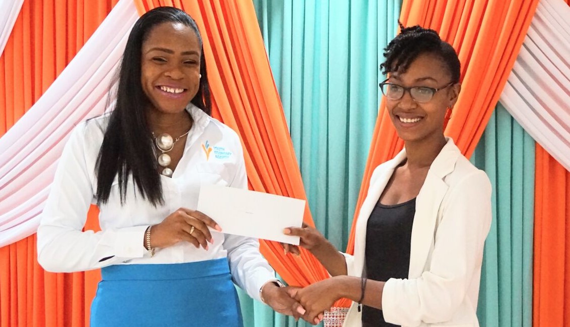 Recipient of Youth Economy Agency grant receives cheque.