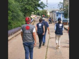 CARITAS volunteers walk through a community.