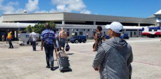 Passengers arrive at a Caribbean airport.