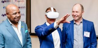 The Honorable Edmund Bartlett (left), Minister of Tourism and Mats Johansson (right), co-founder and president of EON Reality, listen keenly to Adam Stewart, Sandals Resorts International’s executive chairman as he describes a fully equipped Sandals kitchen while viewing through VR goggles on the EON Reality XR Platform. This demonstration formed part the launch of the SCU/EON Reality partnership to use AI in hospitality education.