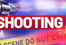 Two men killed in separate shootings in Castries Graphic artwork of a revolver against a blue background and red lettering saying 'shooting' above a yellow police crime scene tape.