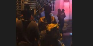 Crowd and emergency responders at scene of Vieux Fort double homicide.