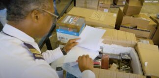 Customs Officer examines food items packed in a box.