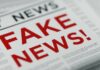 Folded newspaper with 'Fake News' written in bold red letters as a headline.