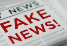 Police warn against false reports as two held in Auguste case Folded newspaper with 'Fake News' written in bold red letters as a headline.
