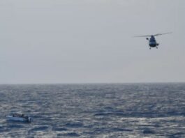 French Panther helicopter hovers above vessel in distress at sea northwest of Saint Lucia before rescuing the vessel's six passengers.
