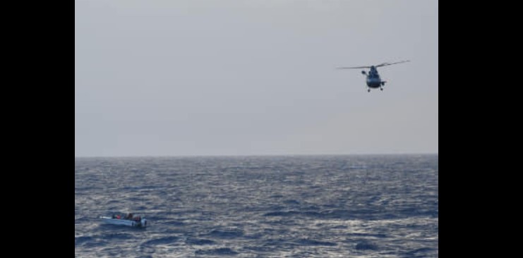 French Panther helicopter hovers above vessel in distress at sea northwest of Saint Lucia before rescuing the vessel's six passengers.