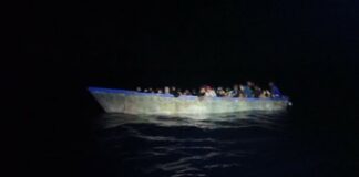 Illegal Caribbean migrants aboard overloaded vessel in the dark at sea off Puerto Rico.