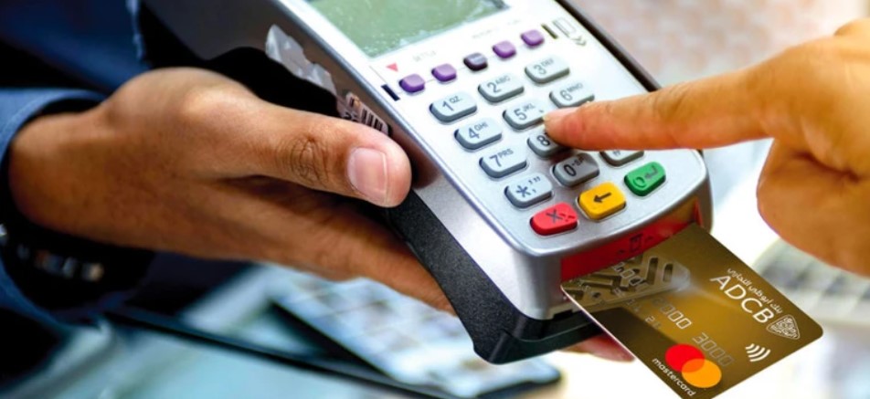 Purchase with credit card at point of sale machine.