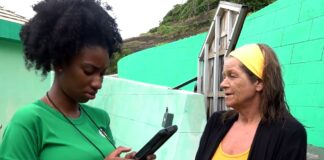 Female enumerator with electronic tablet in hand interviews a woman for the Saint Lucia national housing and population census.