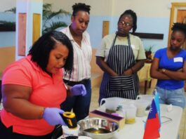 PHOTO: Facilitator Kishma Louis (far left )demonstrating to participants how to mix ingredients in the soap-making process.