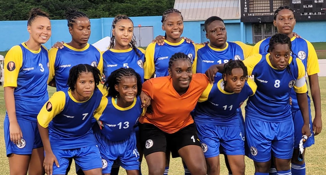 Team of young Saint Lucia women footballers pose for photo.
