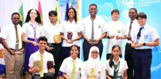 Top performers in the Caribbean Examinations Council CAPE exams pose with their awards.