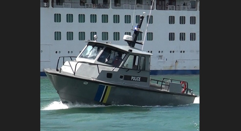 Marine Police vessel in Castries harbour in front of moored cruise ship.