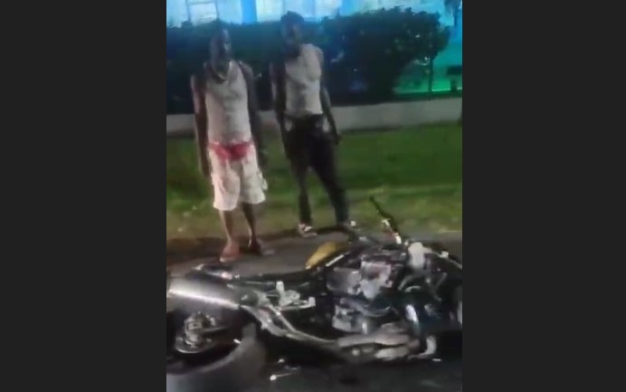 Motorcycle on the ground after collision with cow