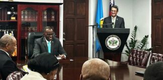 Taiwan's Ambassador addresses government ministers during handover of funds to support Saint Lucia independence celebrations.