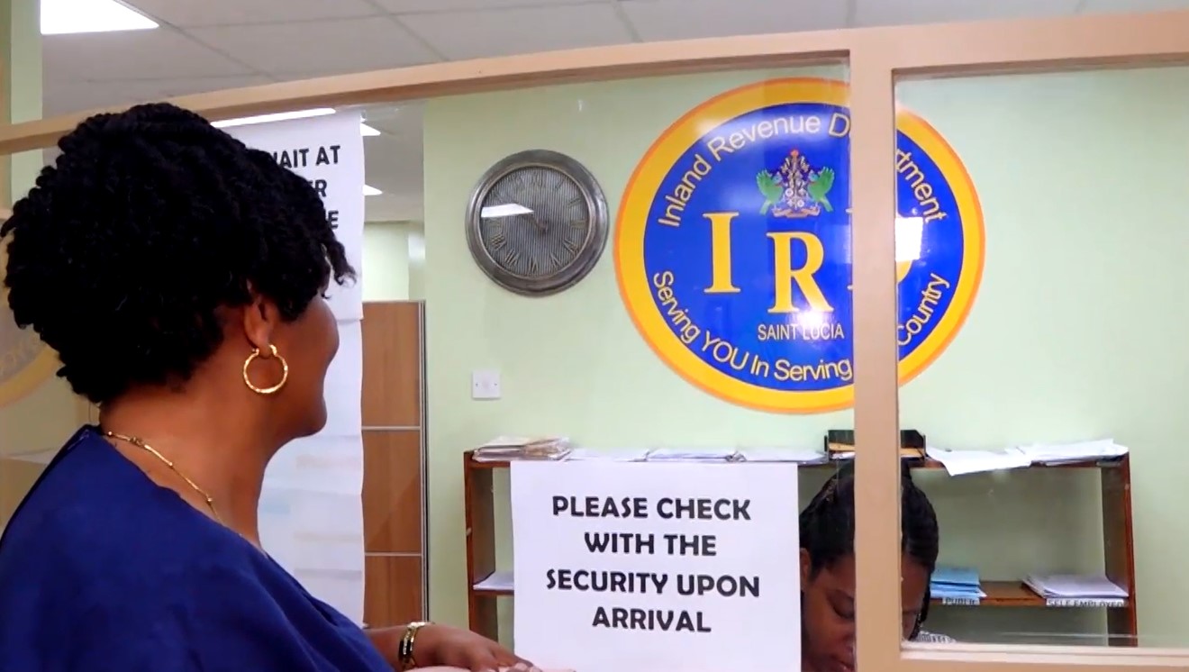 Teller at the Inland Revenue Department (IRD) attends to a customer.