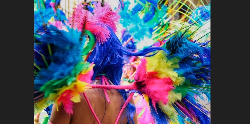 A Carnival reveler in costume with feathers