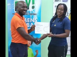 Female football coach receives coaching certificate.