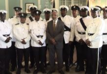 Antigua police honourees pose for photo with their country's Deputy Governor General.