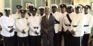 Antigua police honourees pose for photo with their country's Deputy Governor General.