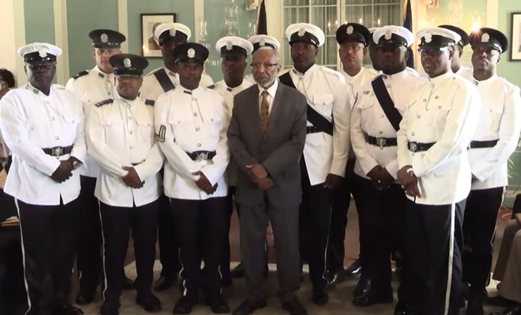 Antigua police honourees pose for photo with their country's Deputy Governor General.