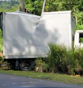 Delivery truck with dented side after Micoud collision.