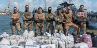 French Navy crew poses with bales of cocaine seized during Caribbean Sea patrol.