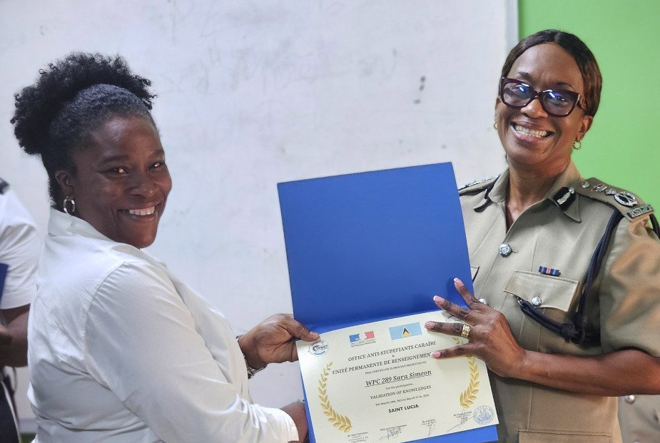 Police Commissioner Crusita Descartes-Pelius (Right), presents certificate to female police officer who participated in training workshop.