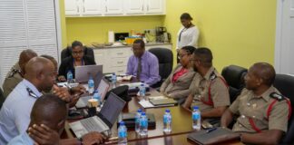 Participants sit around the table at Saint Lucia Fire Service legislation review meeting.