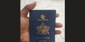 Hand holding Saint Lucia passport.
