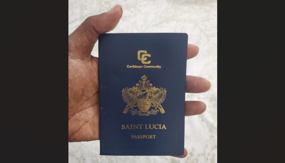 Hand holding Saint Lucia passport.