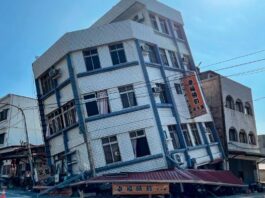 Multi-story building leans precariously after Taiwan earthquake.