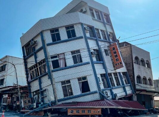 Multi-story building leans precariously after Taiwan earthquake.