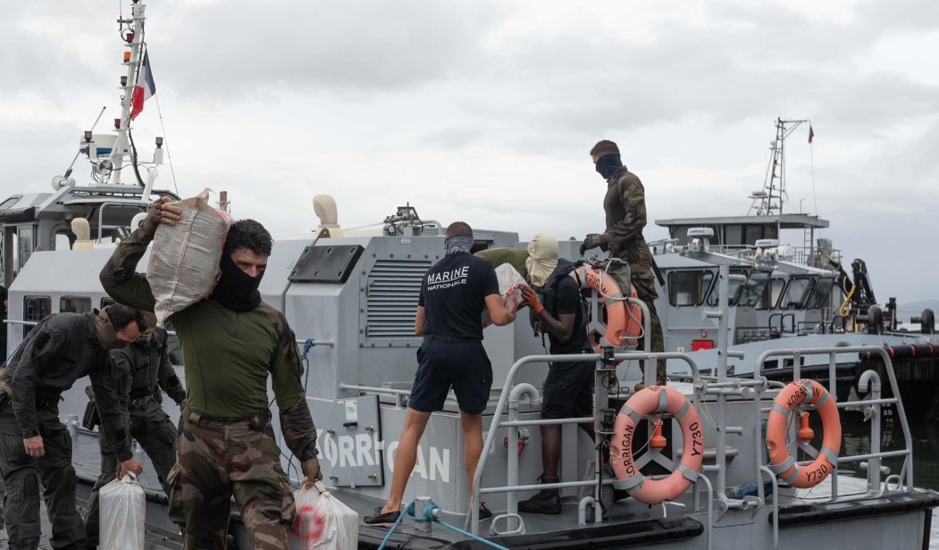 French Navy officials remove confiscated drugs from a vessel.