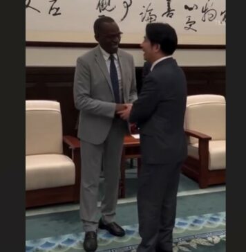 Prime Minister Philip J. Pierre shakes the hand of Taiwan's new President.