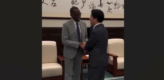 Prime Minister Philip J. Pierre shakes the hand of Taiwan's new President.