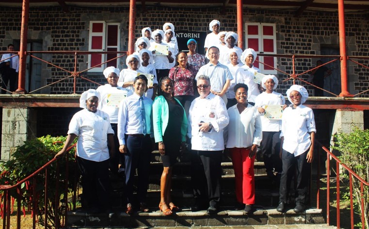 Sir Arthur Lewis Community College student chefs pose with others.