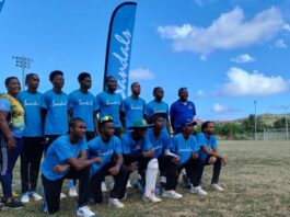 Sandals supported youth cricketers pose for a photo.