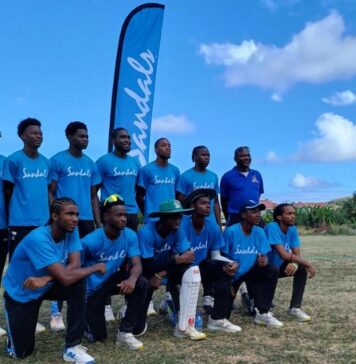 Sandals supported youth cricketers pose for a photo.