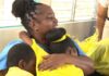 Students hug the outgoing principal of the Aux Lyon Combined School.