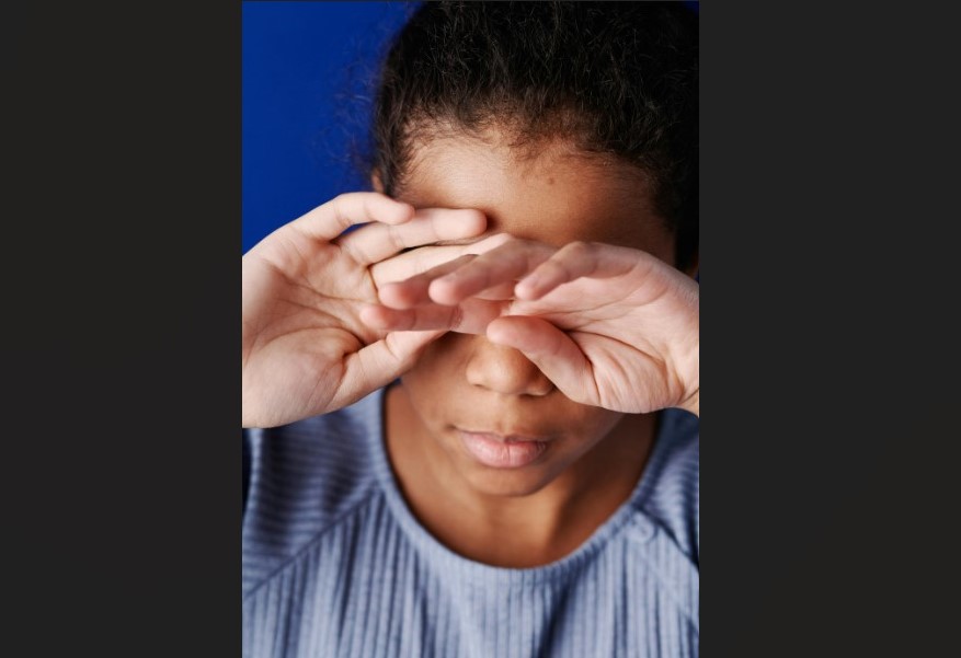 Girl wiping her tears.