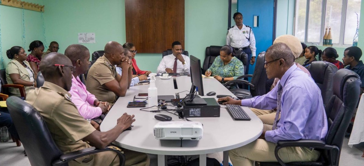 Jeremiah Norbert sits at the head of a table with BCF officials.