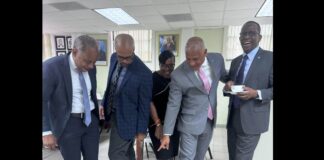 Philip J. Pierre and colleagues pose with sneakers.
